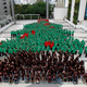 852 students gather outside a mall in Bangkok to break the record for the biggest human Christmas tree.